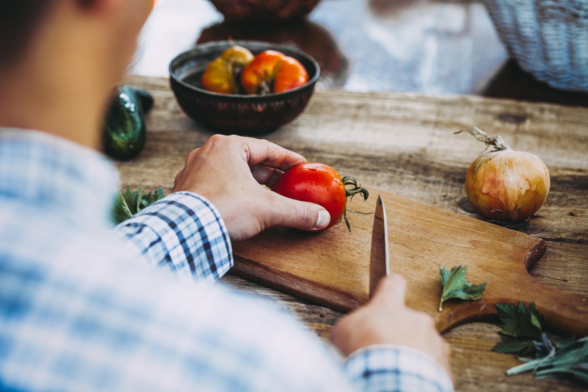Chef arranging ingredients on wooden table